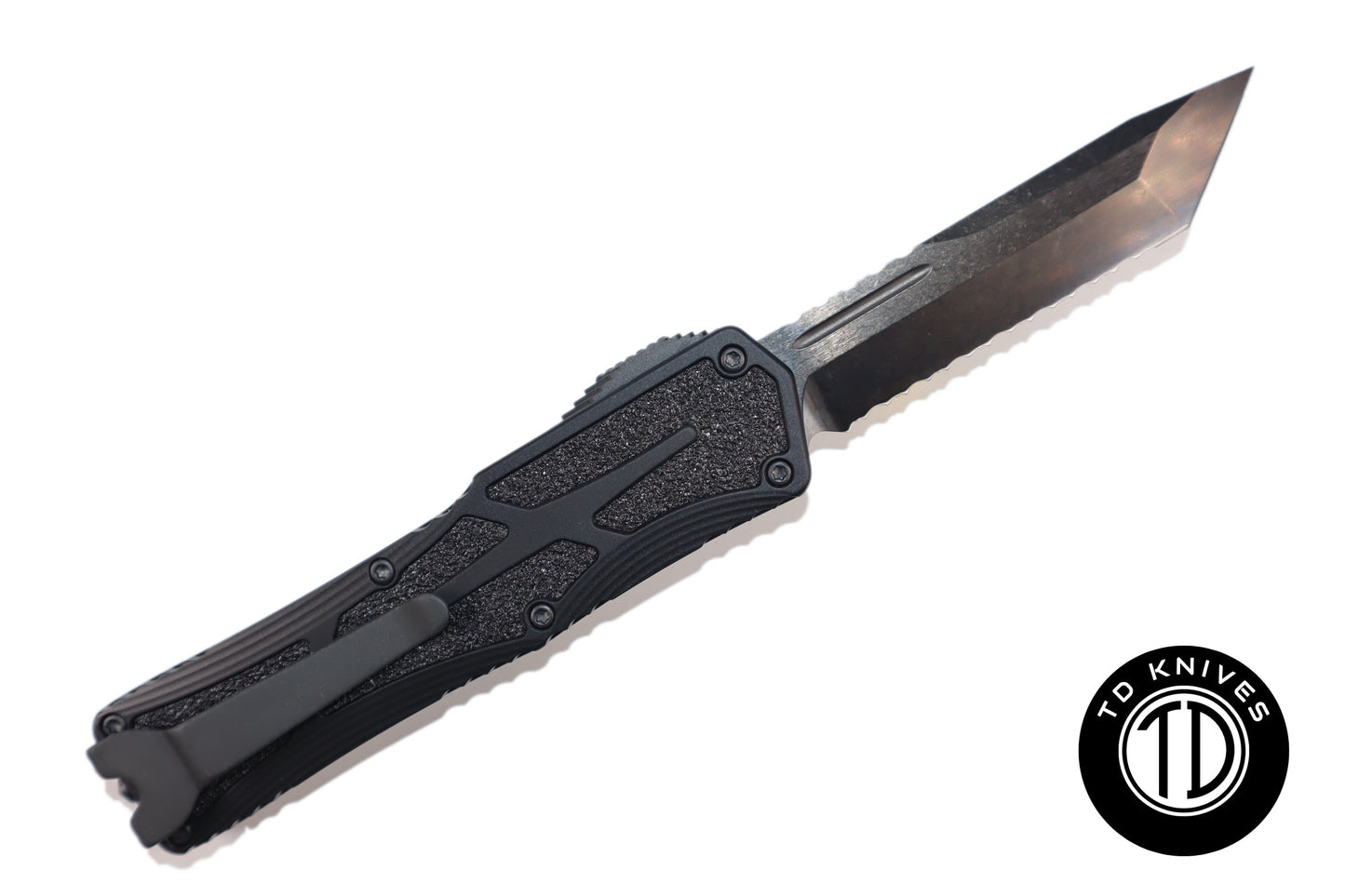 HERETIC - Colossus in Tactical Black W/ Black Grip Inlays & DLC Full Serrated Tanto Edge Blade Finish. Model # H040-6C-T