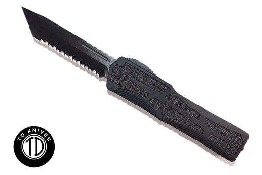 HERETIC - Colossus in Tactical Black W/ Black Grip Inlays & DLC Full Serrated Tanto Edge Blade Finish. Model # H040-6C-T